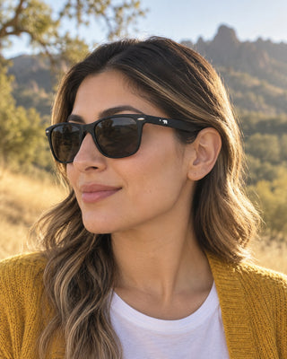 Pinnacles polarized sunglasses worn by a woman on an oak-dotted hillside near Pinnacles National Park